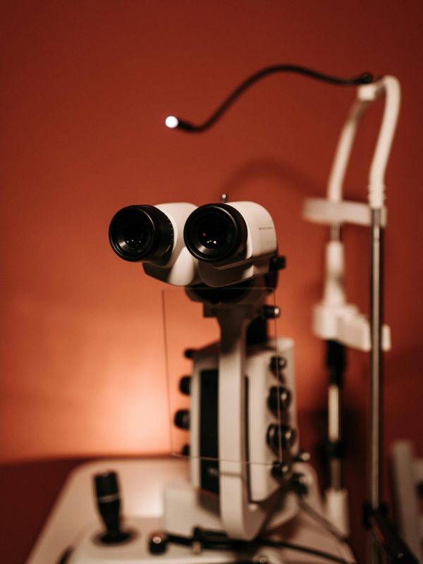 Detailed close-up of ophthalmology equipment used for eye examinations with a warm tone background.